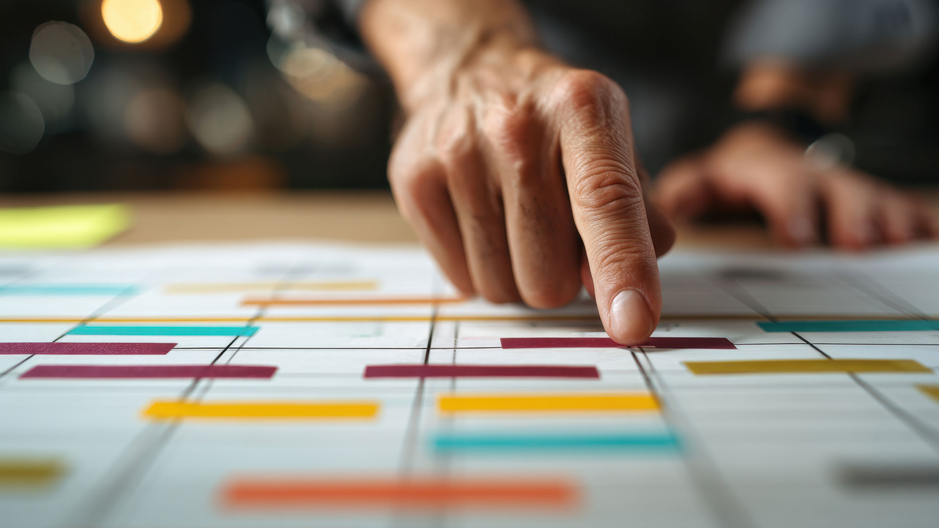 Man looking over plans with his hand pointing at a specific section.