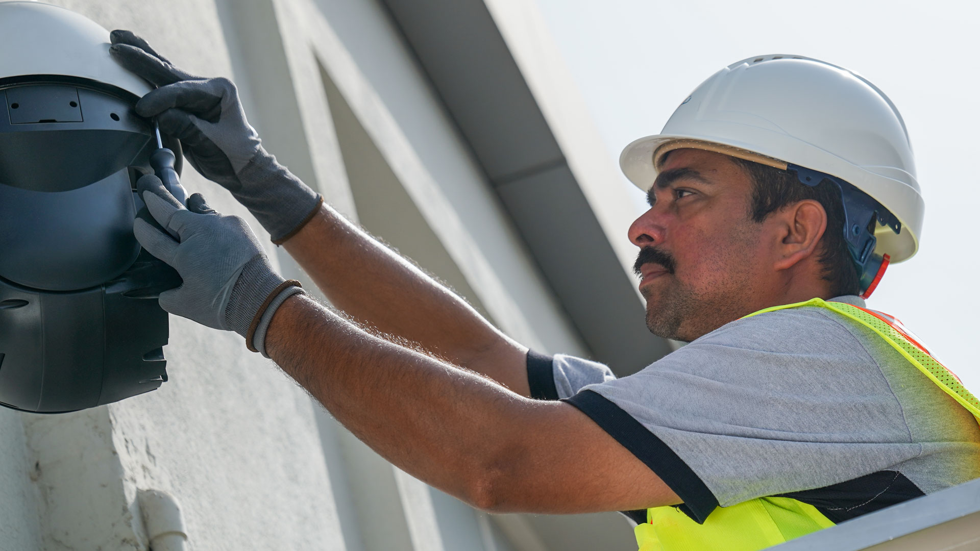 Convergint worker installing camera