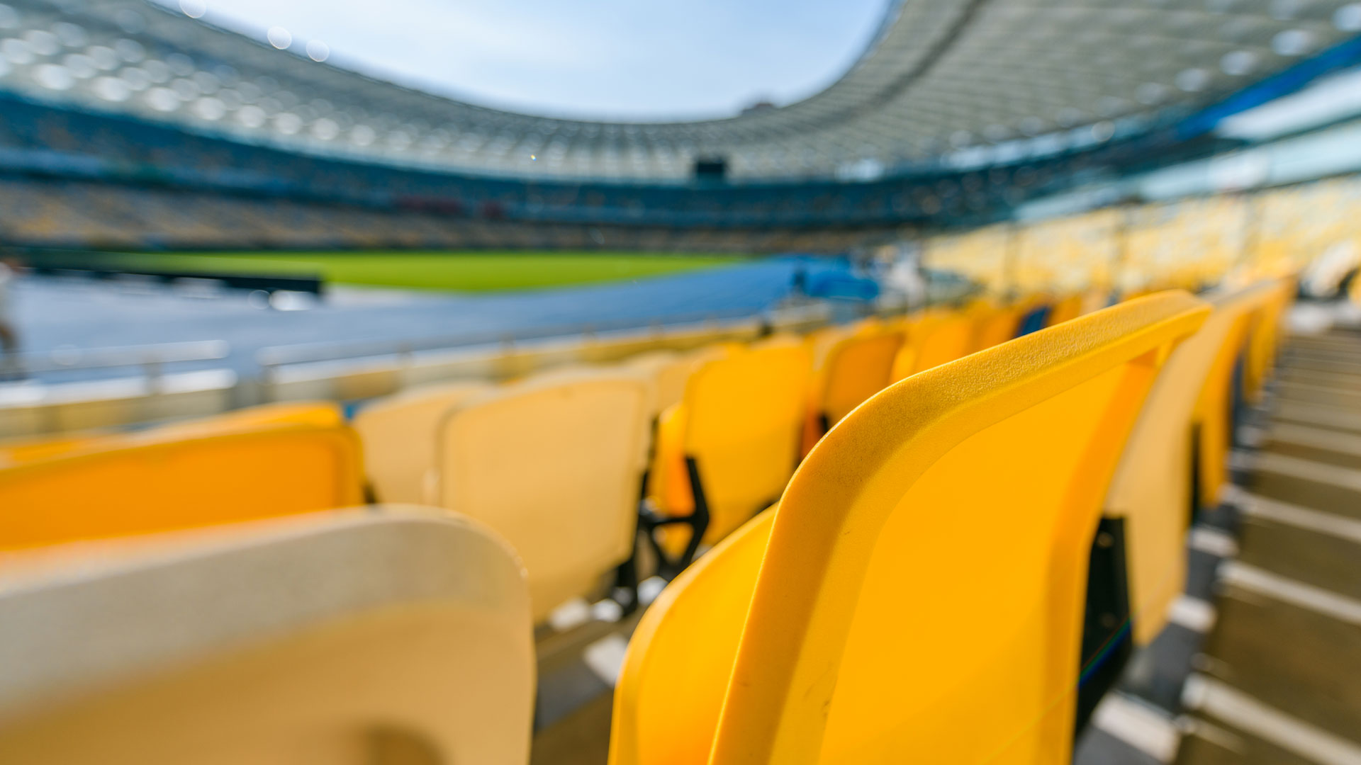 selective focus of yellow stadium seats on foodball stadium