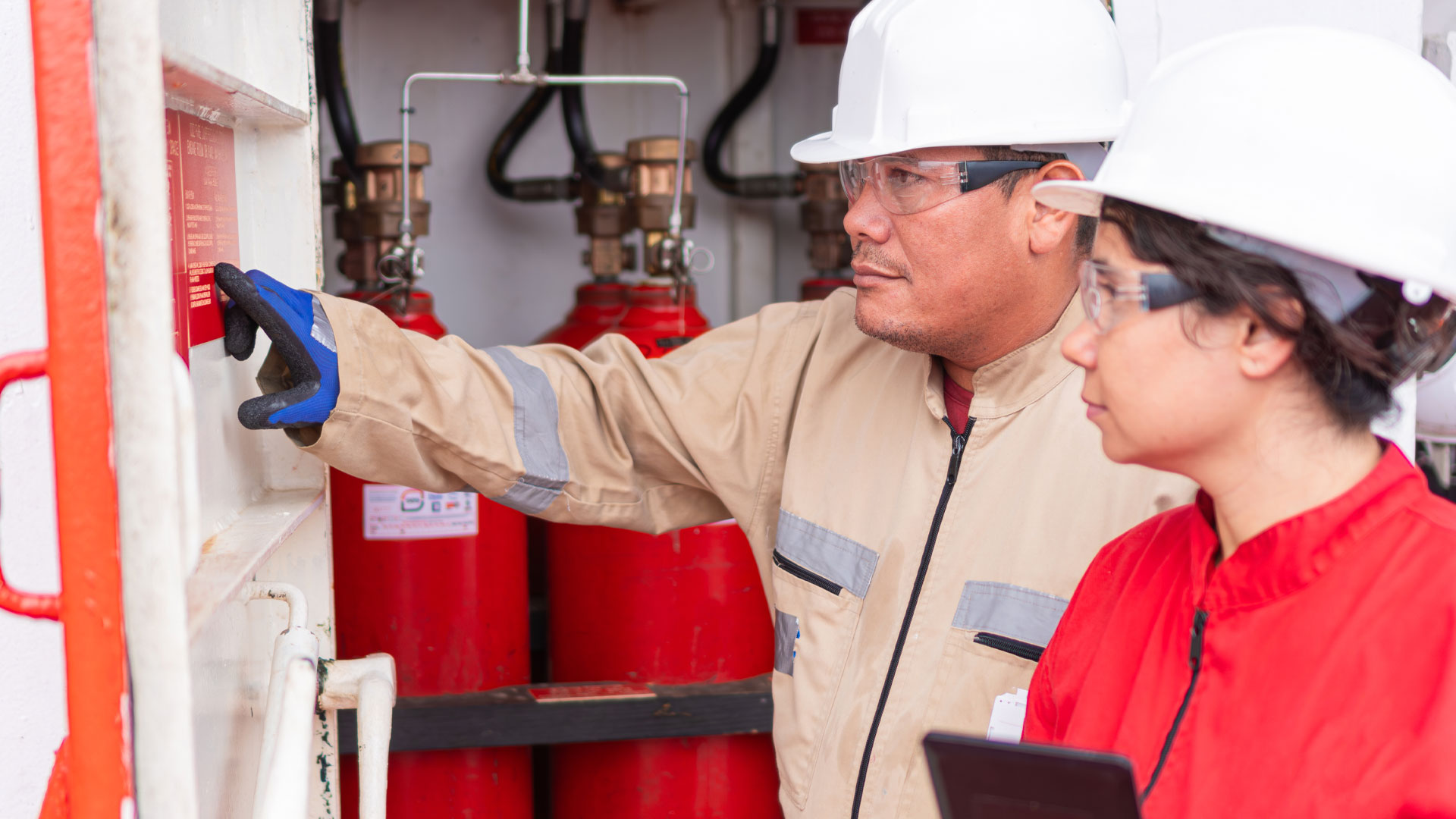 Pair of professionals gauging metrics at industrial site