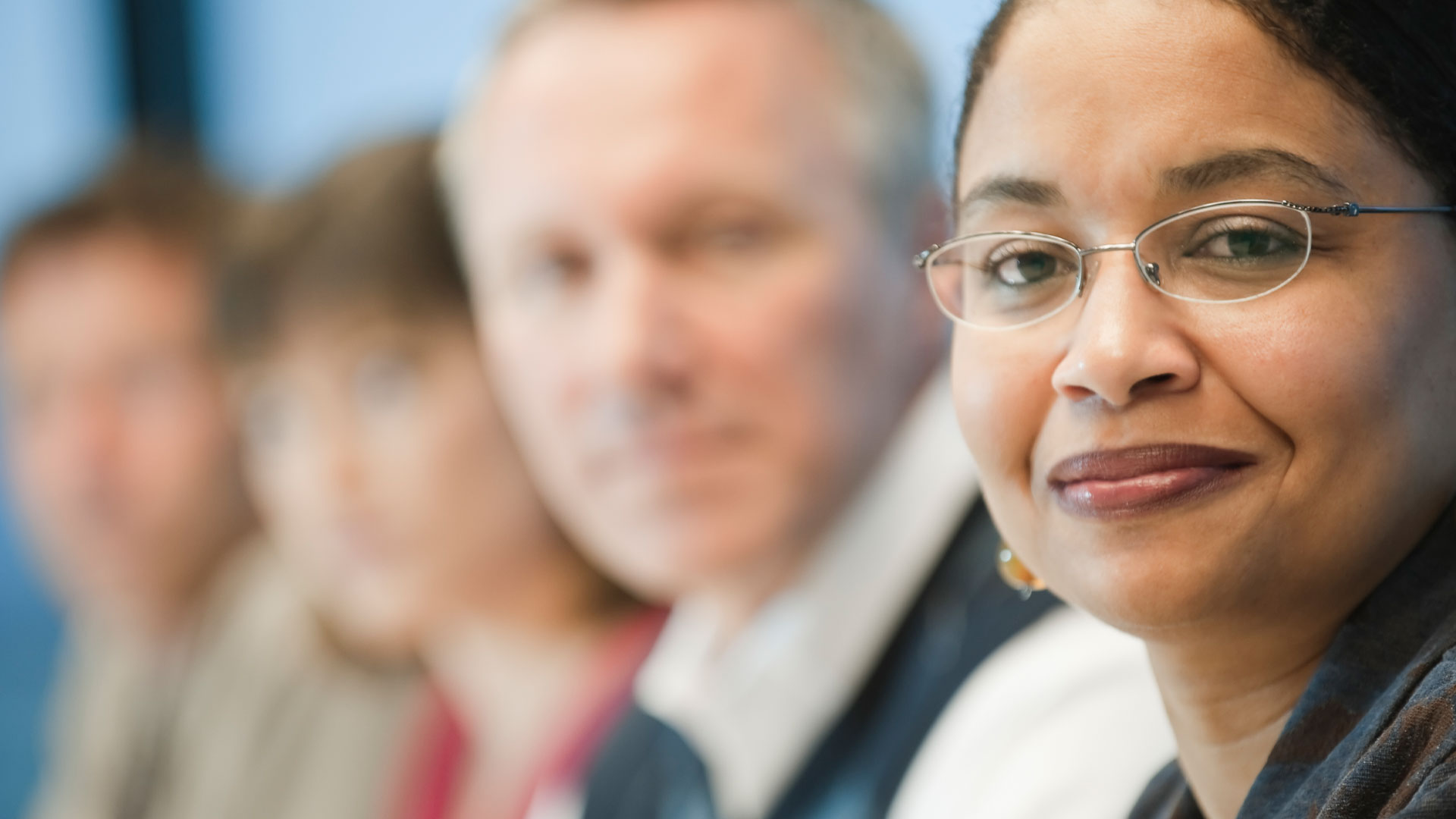 Mixed race team of business people led by a black businesswoman.