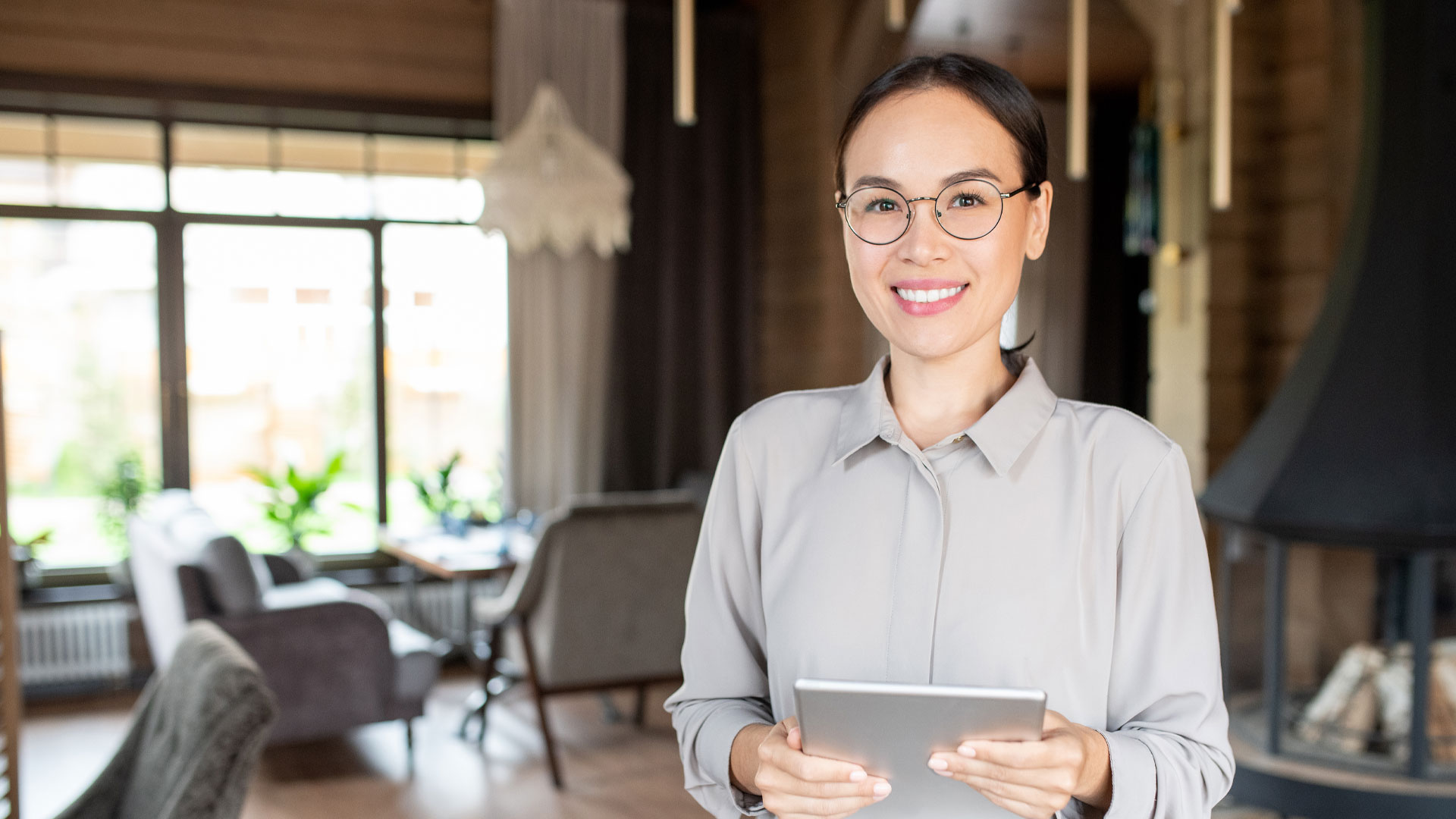 Young successful owner of modern restaurant or cafe holding touchpad