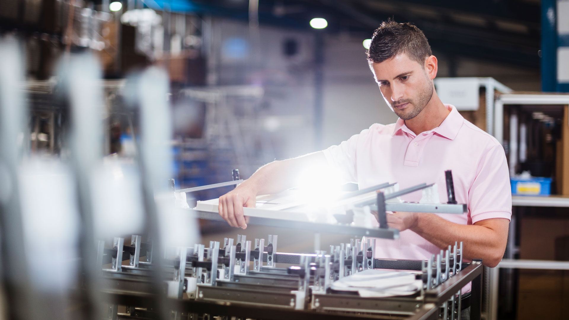 Businessman standing in shop floor, testing products