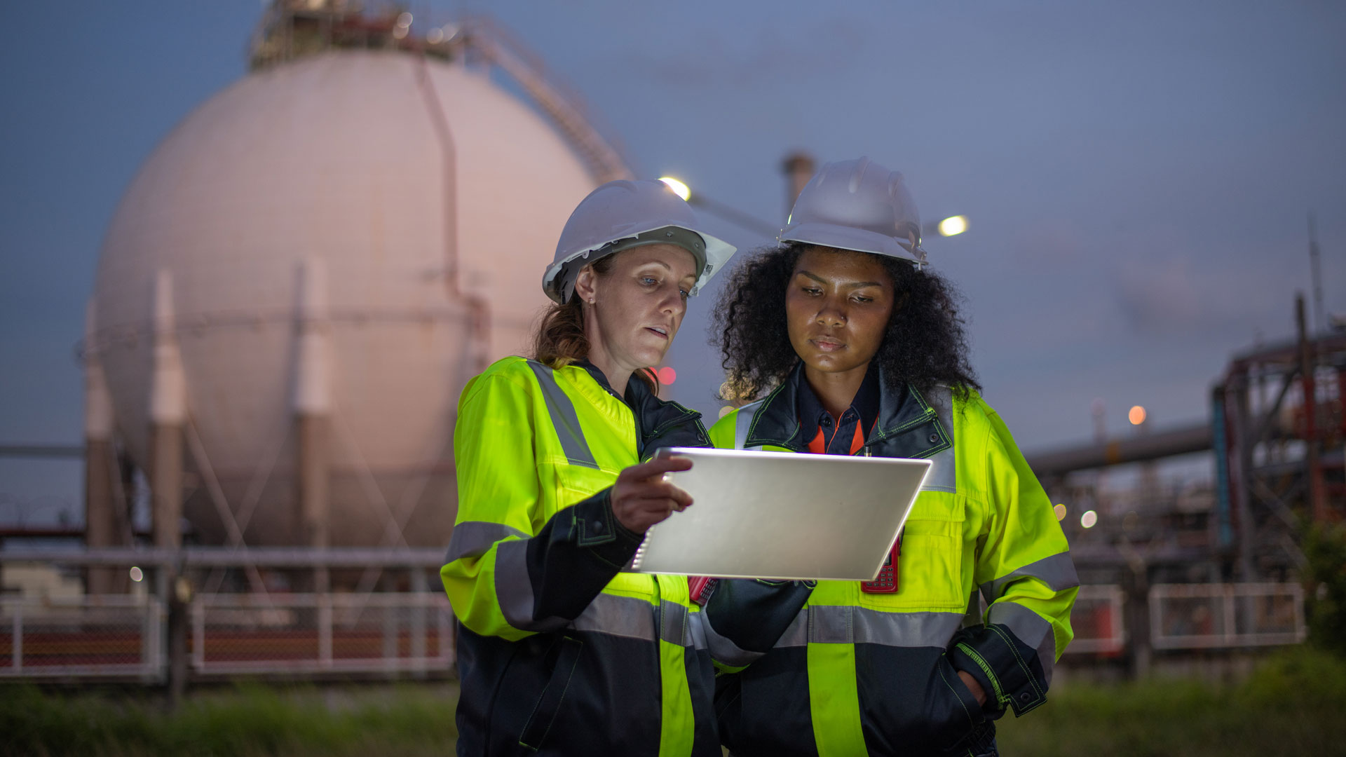 Engineers wearing safety gear, including hard hats examining survey