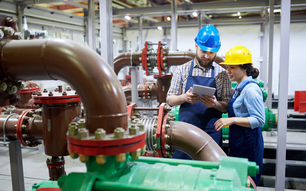 Two engineers in a water treatment facility