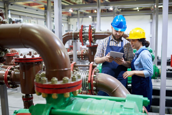 Two engineers in a water treatment facility