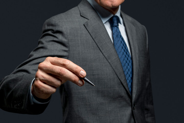 Businessman using a pen and signing
