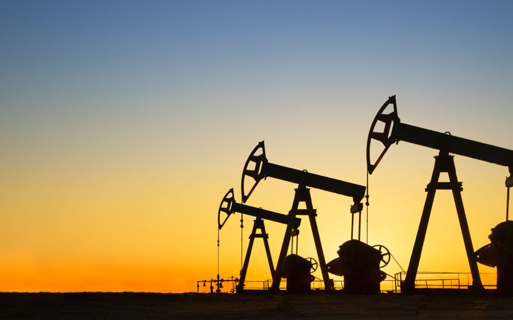 Silhouette of oil wells at sunset