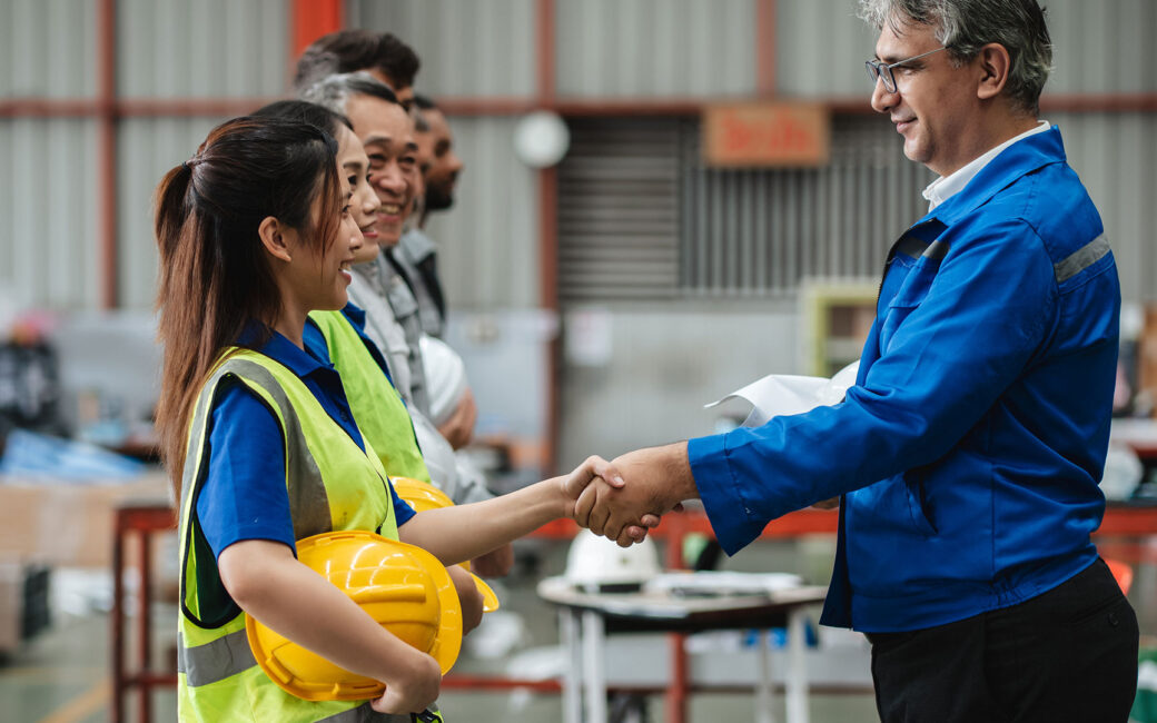 Team of engineers and foreman gather for a safety meeting
