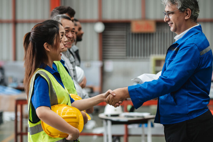 Team of engineers and foreman gather for a safety meeting