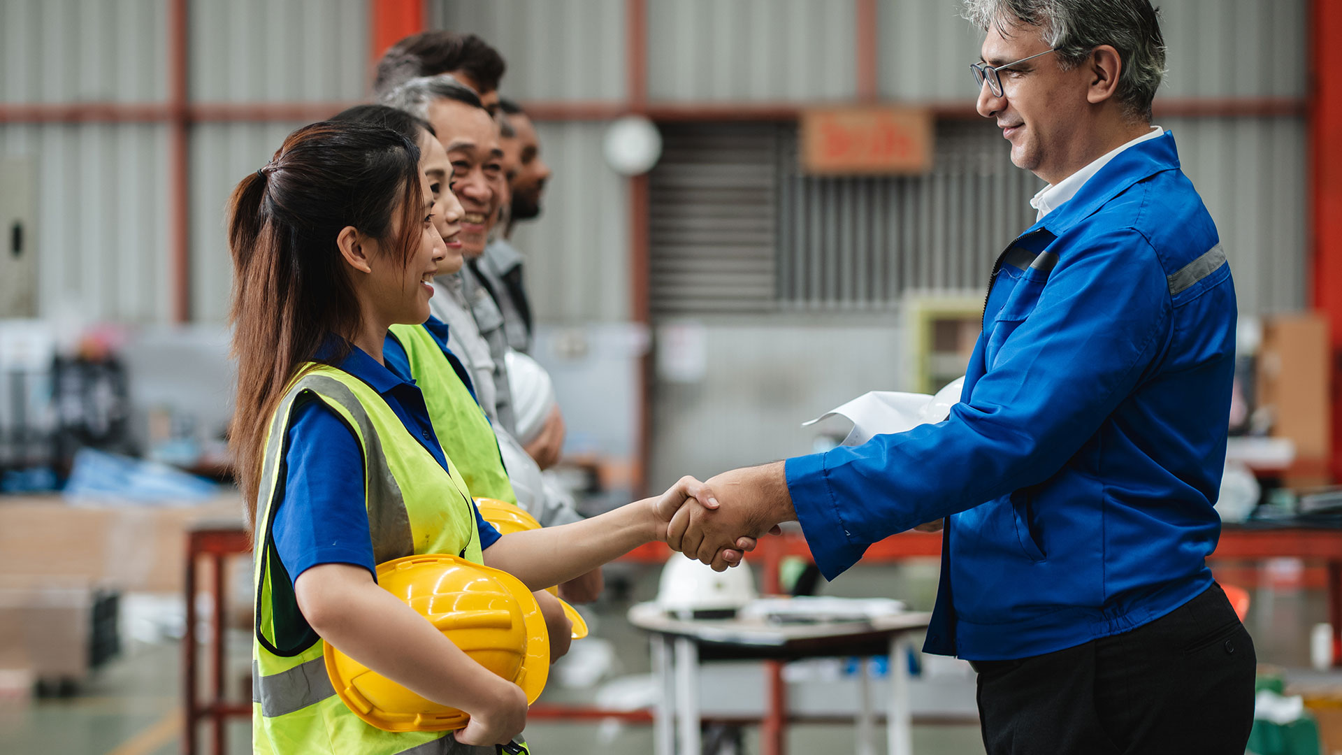 Team of engineers and foreman gather for a safety meeting