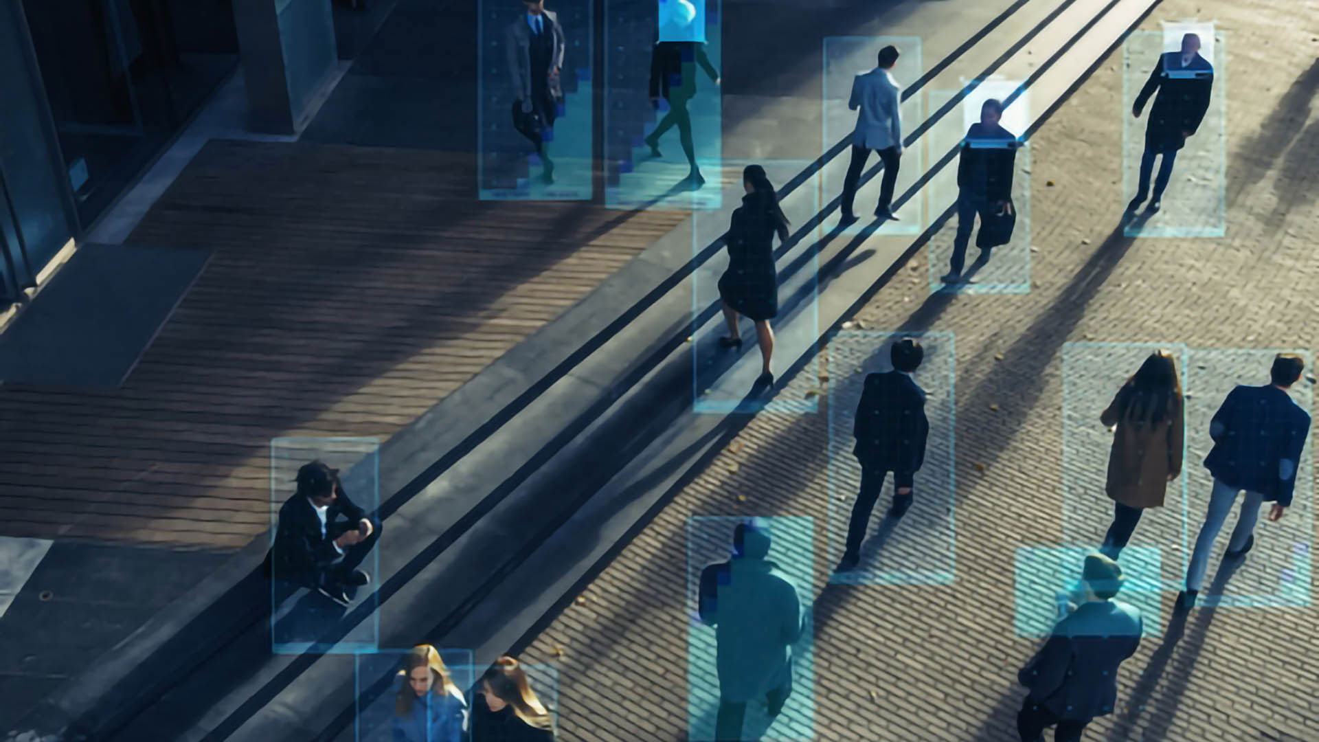 pedestrians walking by a business building with blue rectangles tracking their movements
