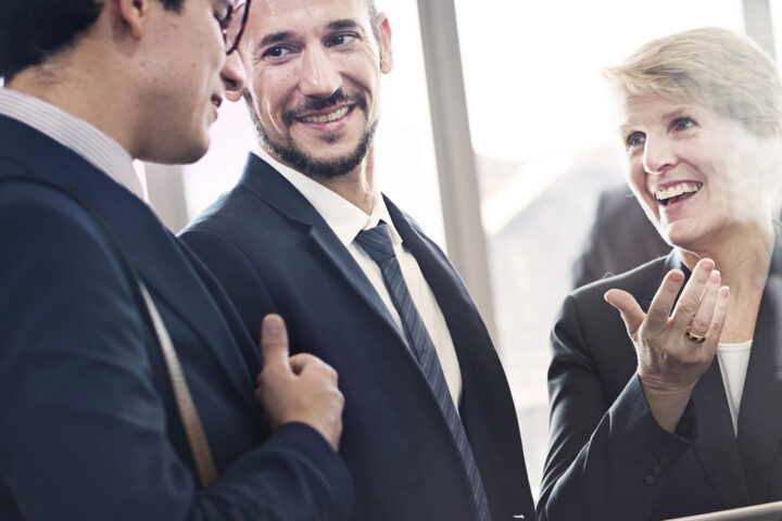 Group of business people having a successful, fun conversation