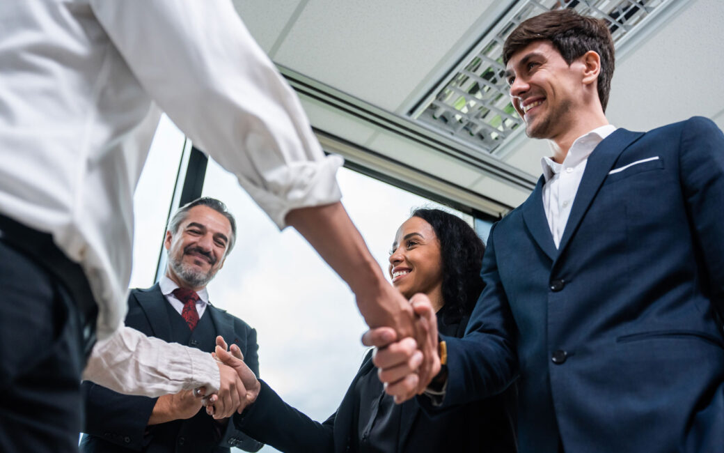 Making a handshake together while stand in office.