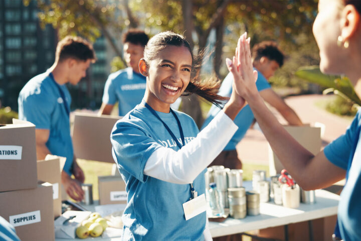 Outdoor, volunteer and group with high five, performing community service