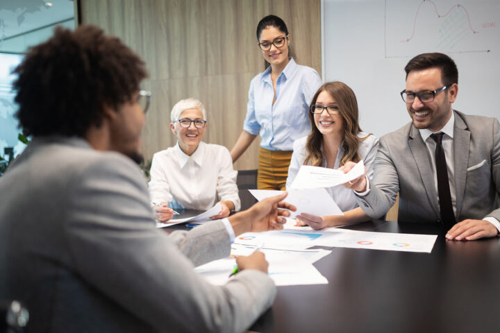Successful group of business people at work in an office having a meeting